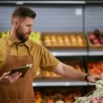 Grocery Worker Organizing Produce in Fresh Section