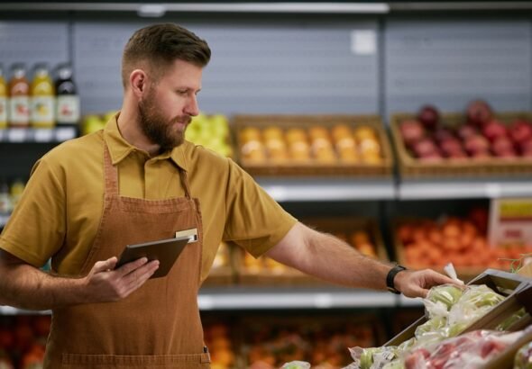 Grocery Worker Organizing Produce in Fresh Section