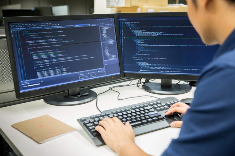 Male,Programmer,Working,On,Desktop,Computer,At,White,Desk,In